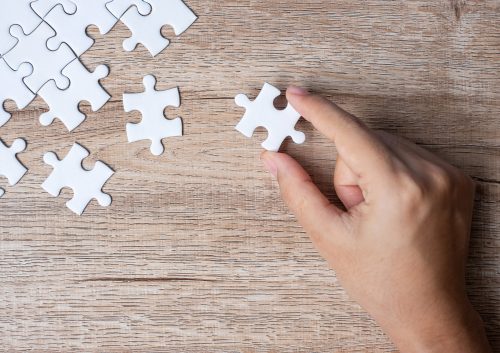 Businessman hand connecting puzzle piece. Business solutions, m Businessman hand connecting puzzle piece. Business solutions, mission target, successful, goals, cooperation, partnership and strategy concept